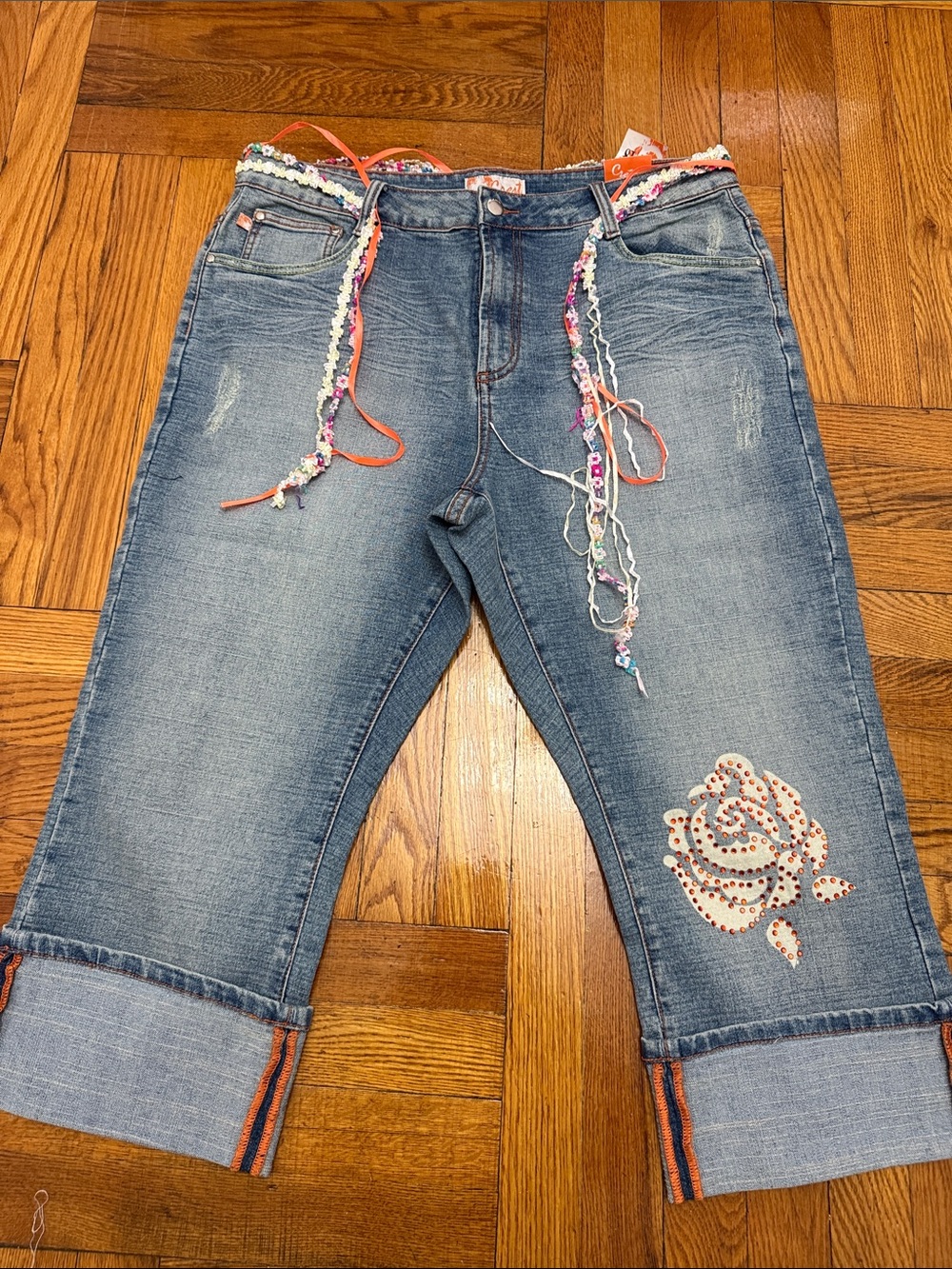 Crest Embellished Light Blue Cropped Jeans with Multicolor Accents
